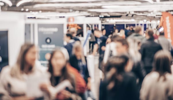Abstract blurred people at exhibition hall of expo event trade show. Business convention show or job fair. Business concept background