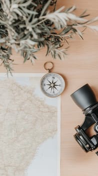 A flat lay of a compass, map, and binoculars on a wooden table, perfect for planning your next adventure.