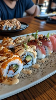 A mouthwatering sushi platter featuring rolls with fresh ingredients and a drizzle of sauce, ready to enjoy.