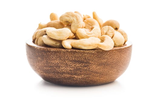 Roasted cashew nuts in bowl isolated on a white background.