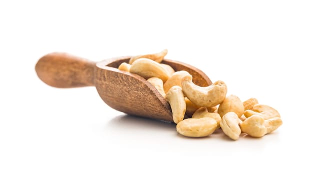 Roasted cashew nuts in scoop  isolated on a white background.