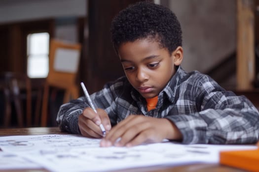 Elementary school student concentrating on solving math problems on a worksheet at his desk