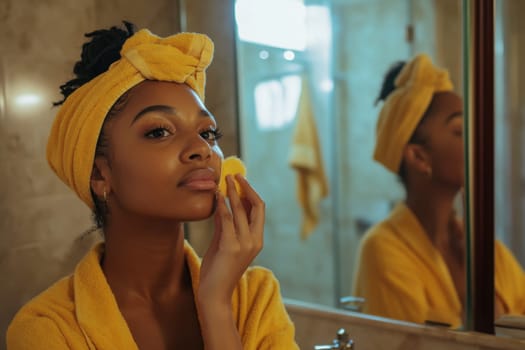 Model using a sponge to apply foundation on her face, reflecting in the bathroom mirror during her daily beauty routine