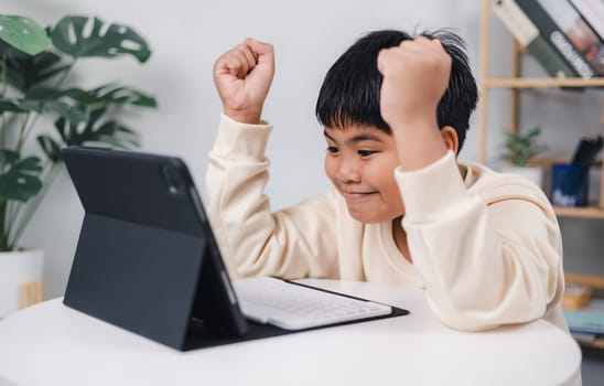 Educational of tech concept, Staying at home, Asian boy student using tablet learning. Presenting a modern educational way of life. Virtual internet online class from school teacher.
