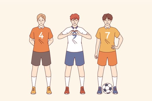 Team of soccer players plays in professional league, and poses in sports uniforms with numbers. Football players from school team smile, preparing for game and dream of competing in competitions