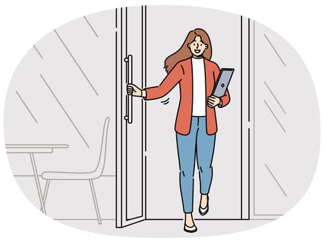 Woman freelancer with laptop leaves cafe with transparent window and rejoices at opportunity to work where it is convenient. Successful businesswoman opens door of meeting room in modern office