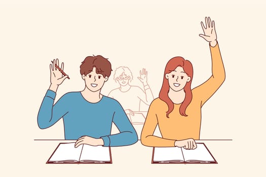 Students receive education, sitting at desks at university and raising hands up. Back to school concept for teenage students enjoying opportunity to gain new knowledge or diploma for college