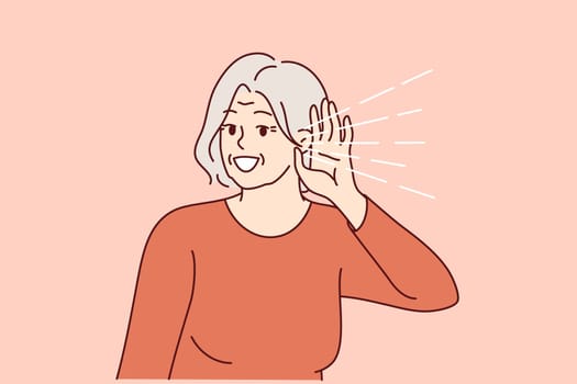 Elderly woman experiences deafness and puts hand to ear to hear interlocutor. Gray-haired lady needs to treat deafness and buy hearing aid, or overhears gossip of neighbors discussing secrets