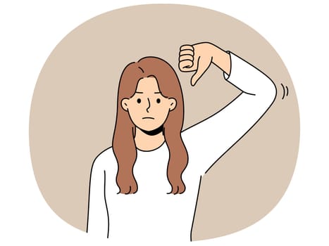 Frustrated woman gives thumbs down as sign of disbelief or rejection of proposed plans. Disgruntled girl makes thumbs down gesture, urging not to spread fake news and misinformation.