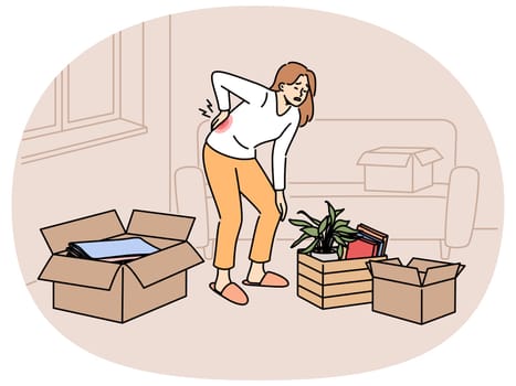 Sick woman moving to new apartment and suffers from back pain, stands among heavy boxes. Lonely tired girl suffers from sciatica or hernia due to moving on own, and needs help of movers