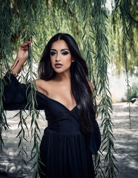 pretty young goth woman under weeping willow tree, AI generated image