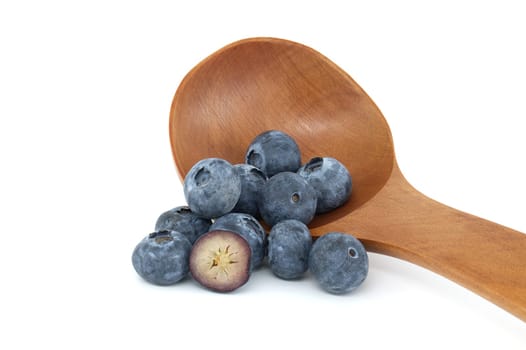 A close-up of juicy blueberries resting in a wooden spoon, elegantly displayed on a white background, showcasing their fresh and natural appeal