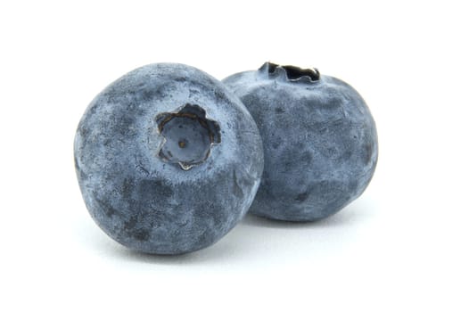 A detailed close-up of two fresh blueberries showcasing their texture and color on a clean white background. Perfect for healthy eating, nutrition, and fruit-themed designs