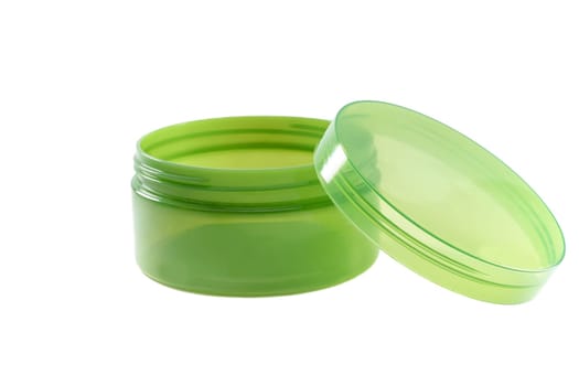 Empty translucent green jar with lid, ideal for beauty product packaging.