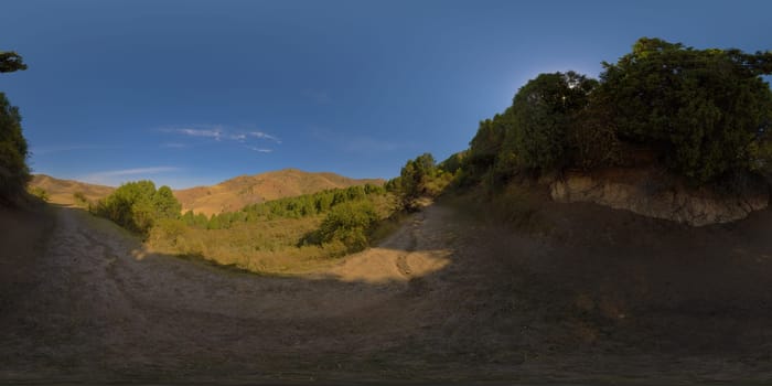 Full Spherical panorama of dry yellow dusty footpath in autumn foothills at sunny day in equirectangular projection