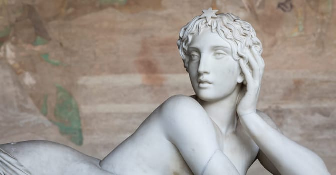 Pisa, Italy - 29 June 2023: sad statue in cemetery. Vintage white marble sculpture, woman sorrow