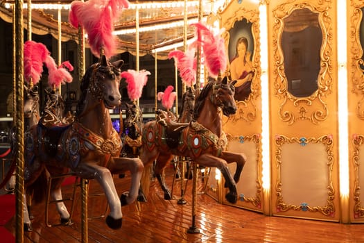 Florence, Italy - 30 April 2024. Carousel horses. Antique merry-go-round, vintage nostalgia concept