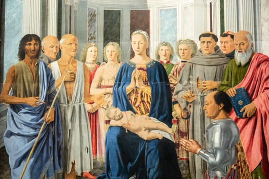 Milan, Italy - 23 September 2023: Brera antique painting museum. Madonna and child with saints, angels and Federico da Montefeltro, by painter Piero della Francesca, 1470