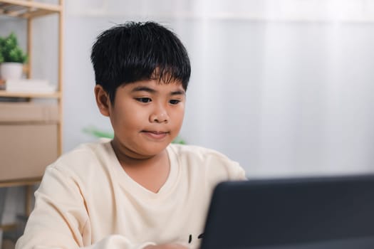 Asian boy student using tablet learning, Educational of tech concept, Staying at home, Presenting a modern educational way of life, Virtual internet online class from school teacher.
