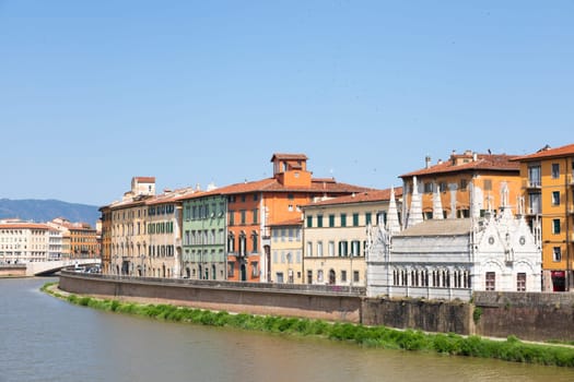 Pisa, Italy - 29 June 2023: colourful buildings on Arno river. Urban skyline, travel destination.