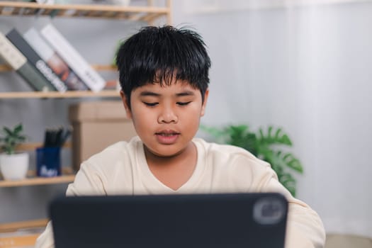 Asian boy student using tablet learning, Educational of tech concept, Staying at home, Presenting a modern educational way of life, Virtual internet online class from school teacher.