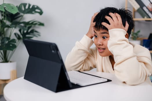 Asian boy student using tablet learning, Educational of tech concept, Staying at home, Presenting a modern educational way of life, Virtual internet online class from school teacher.