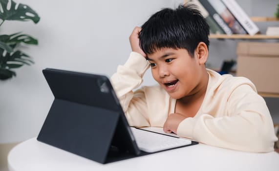 Asian boy student using tablet learning, Educational of tech concept, Staying at home, Presenting a modern educational way of life, Virtual internet online class from school teacher.