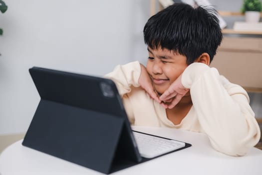 Asian boy student using tablet learning, Educational of tech concept, Staying at home, Presenting a modern educational way of life, Virtual internet online class from school teacher.