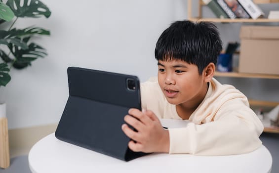 Asian boy student using tablet learning, Educational of tech concept, Staying at home, Presenting a modern educational way of life, Virtual internet online class from school teacher.