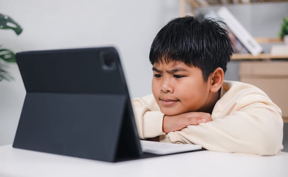 Asian boy student using tablet learning, Educational of tech concept, Staying at home, Presenting a modern educational way of life, Virtual internet online class from school teacher.