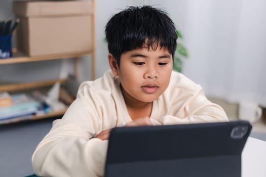 Asian boy student using tablet learning, Educational of tech concept, Staying at home, Presenting a modern educational way of life, Virtual internet online class from school teacher.