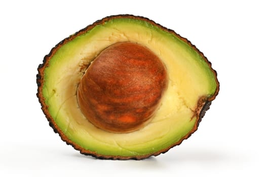 Avocado (hass or bilse variety) cut in half, seed still inside, closeup detail isolated on white background
