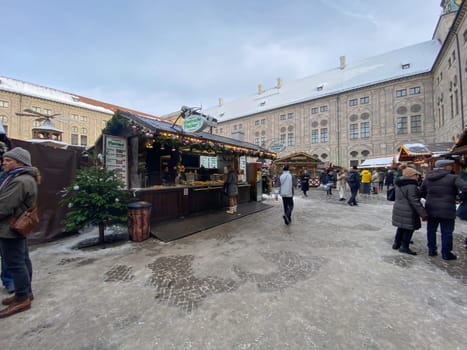 Munich, DE, Dec. 19 2022  Christmas market in the courtyard of the Munich Residenz, featuring festive stalls, decorations, and visitors enjoying the seasonal atmosphere