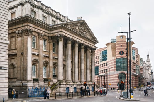 London, United Kingdom - February 02, 2019: People walking under Mansion House building - Lord Mayor of London residence on overcast cloudy day