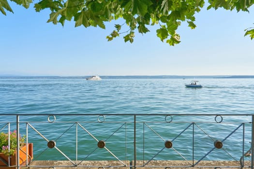 View of Lake Constance, Bodensee from the shady tree-lined promenade in Meersburg in Germany in the sunshine
