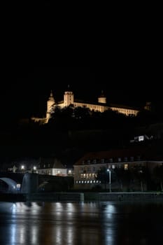 Illuminated Marienberg Fortress above the city of Wuerzburg on the River Main in Germany at night