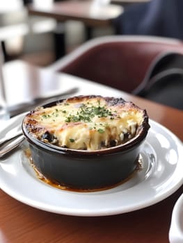Cooking a fresh homemade moussaka recipe meal. Tasty Dish of Food with cheese