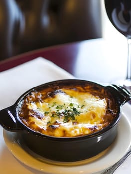 Cooking a fresh homemade moussaka recipe meal. Tasty Dish of Food with cheese