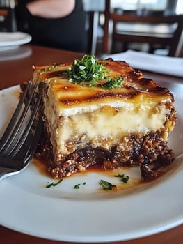 Cooking a fresh homemade moussaka recipe meal. Tasty Dish of Food with cheese