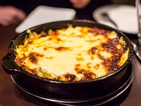 Cooking a fresh homemade moussaka recipe meal. Tasty Dish of Food with cheese