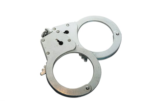 Metal handcuffs on a white isolated background, copy space. High quality photo