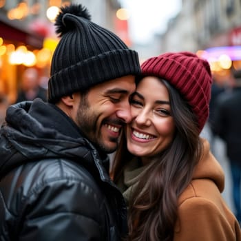 Happy couple in winter attire laughing and embracing on city street with festive lights, capturing the essence of love, joy, and holiday spirit in an urban setting.