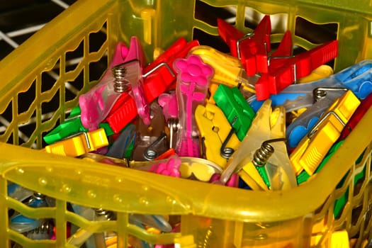 colorful clothespins in a basket in a closeup