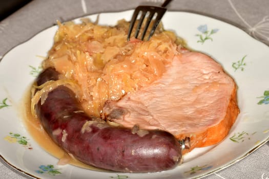 blood sausage and cured cooked pork from the cutlet string and sauerkraut