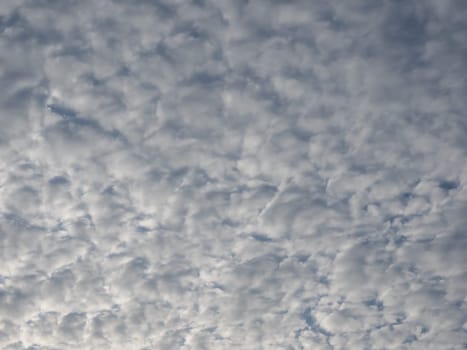 dramatic overcast stormy sky cloudscape with white clouds useful as a background