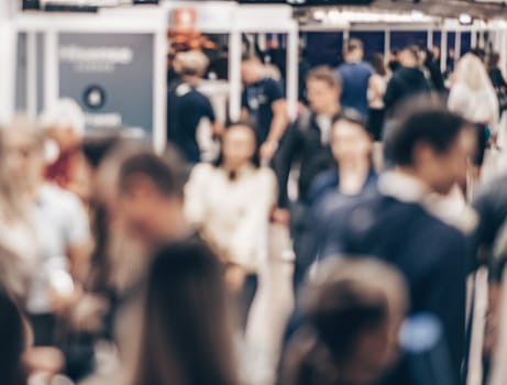 Abstract blurred people at exhibition hall of expo event trade show. Business convention show or job fair. Business concept background