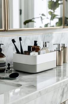 A modern bathroom counter features a neatly arranged storage container holding toiletries, brushes, and other essentials for daily routines.
