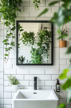 A minimalist bathroom features a sleek sink and mirror, reflecting lush plants hanging on white tiles, creating a serene atmosphere.