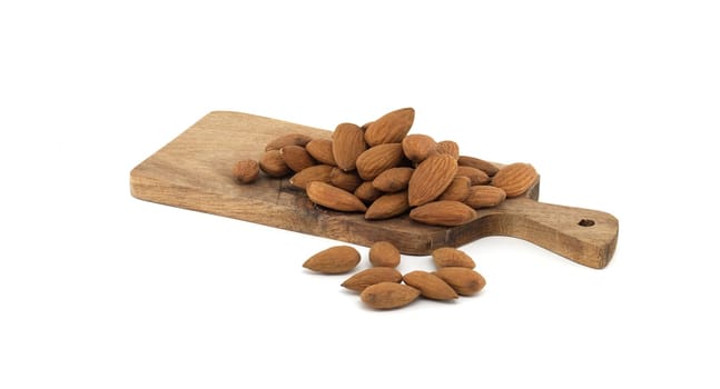 A collection of whole almonds neatly piled on a rustic wooden cutting board, showcasing natural textures and earthy tones, ideal for concepts of healthy eating, nutrition, and organic food