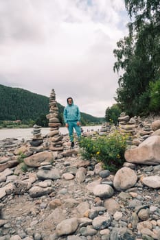 Man at the river Katun at summer day. Trip on Altai Mountains in Altai Republic
